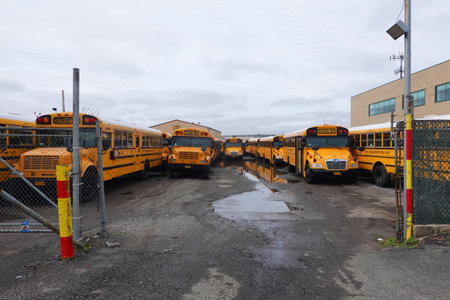 BROOKLYN, NEW YORK - MARCH 19, 2020: School buses parked on the yard in Brooklyn, NY after New York City closed down the public school system to stop the spread of the coronavirus (COVID-19)のeditorial素材
