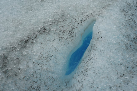 Crevasse filled with water on Perito Moreno Glacier. A crevasse is a deep crack, or fracture, found...