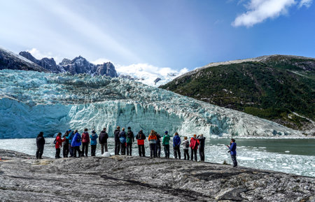 TIERRA DEL FUEGO, CHILE - FEBRUARY 2, 2020: Tourists from Ventus Australis expedition ship landed on the shore near Pia glacier in Parque Nacional Alberto de Agostini in Patagonia, Chileのeditorial素材