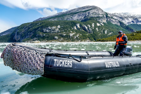 TIERRA DEL FUEGO, CHILE - FEBRUARY 2, 2020: Zodiac boats from Ventus Australis expedition ship transfer tourists on the shore near Pia glacier in Parque Nacional Alberto de Agostini in Patagoniaのeditorial素材