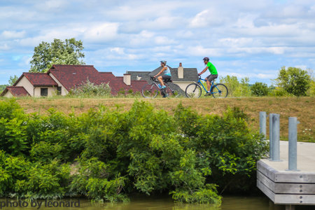 MACEDON, NEW YORK - JULY 22, 2018: Bicyclists enjoy ride at the Erie Canal canal way trail in Upstate New York. It ran 363 miles from the Hudson River in Albany to Lake Erie in Buffaloのeditorial素材