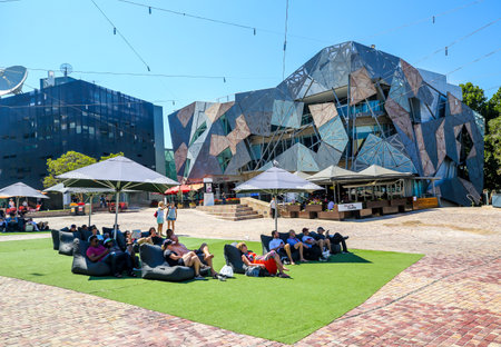 MELBOURNE, AUSTRALIA - JANUARY 21, 2019: Visitors enjoy sunny day at the Federation Square  in Melbourne, Australiaのeditorial素材