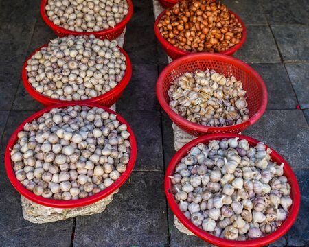 Garlic and onions on display at Old Quarter morning market in Hanoi, Vietnamの写真素材