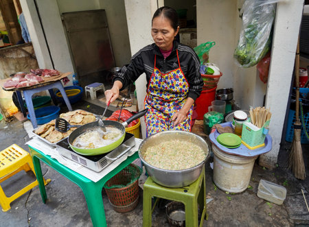 HANOI, VIETNAM - OCTOBER 28, 2019: Local vendors selling food at Old Quarter morning market in Hanoi, Vietnamのeditorial素材