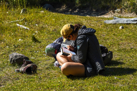 EL CHALTEN, ARGENTINA  - FEBRUARY 6, 2020: Adventure tourists rests at the Laguna Torre trail in the Los Glaciares National Park, Santa Cruz Province, Argentinaのeditorial素材