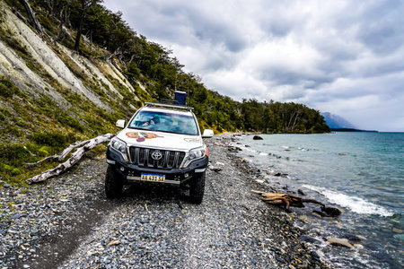 USHUAIA, ARGENTINA- FEBRUARY 4, 2020:  Off road adventure journey at Fagnano  Lake by 4x4 car in...