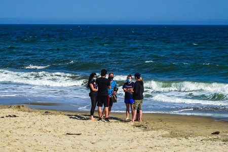 FAR ROCKAWAY, NEW YORK - MAY 15, 2020: Sunbathers and swimmers fill the beach at Rockaway Beach in Jacob Riis Park during COVID-19 pandemic. New York City beaches are currently closed for swimmingのeditorial素材