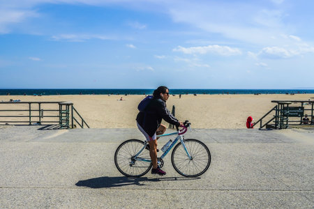 FAR ROCKAWAY, NEW YORK - MAY 15, 2020: Bicyclists enjoy outdoor during COVID-19 pandemic at the Riis Park boardwalk in Far Rockaway, New Yorkのeditorial素材