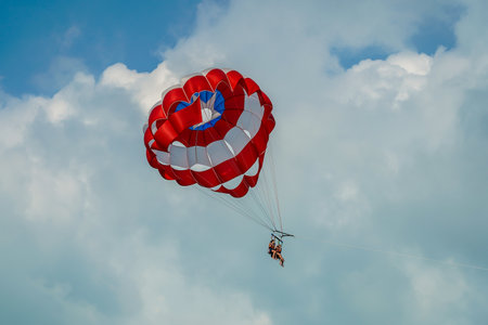 CANCUN, MEXICO - JANUARY 2, 2020: Parasailing in a blue sky in Cancun. Parasailing is a popular recreational activity among tourists in Mexicoのeditorial素材