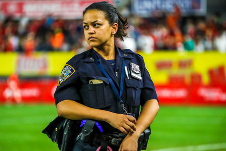 NEW YORK - JULY 24, 2019: NYPD police officer provides security during the 2019 Western Union Cup game between Liverpool FC and Sporting CP  at Yankees stadium in New Yorkのeditorial素材
