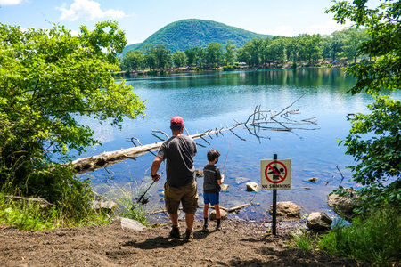 NEW YORK STATE - JUNE 21, 2020: Father and son fishing at Bear Mountain State Park in New York Stateのeditorial素材