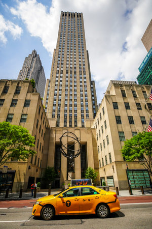 NEW YORK CITY - JULY 16, 2020: Atlas statue by Lee Lawrie with face mask in front of Rockefeller Center in midtown Manhattan during Coronavirus pandemic in New Yorkのeditorial素材