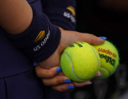 NEW YORK - AUGUST 27, 2019: Ball boy holds US Open Wilson tennis ball at Billie Jean King National Tennis Center in New York. Wilson is the Official Ball of the US Open since 1979のeditorial素材