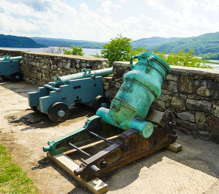 Row of cannons at the historic Fort Ticonderoga in Upstate New York. Fort Ticonderoga, formerly Fort Carillon, is a large 18th-century star fort built by the French in northern New York, United Statesの写真素材