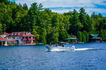 LAKE PLACID, NEW YORK - AUGUST 20, 2020: Boaters enjoy summer day on Lake Placid in New York State's Adirondack Mountainsのeditorial素材
