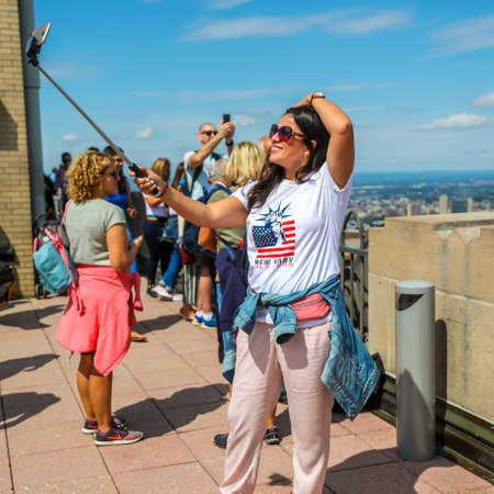 NEW YORK - SEPTEMBER 8, 2019: Tourists take selfie on the Top of the Rock Observation Deck at Rockefeller Center in New Yorkのeditorial素材