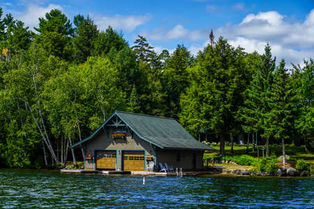 LAKE PLACID, NEW YORK - AUGUST 20, 2020: Luxury boathouse on Lake Placid in New York State's Adirondack Mountainsのeditorial素材