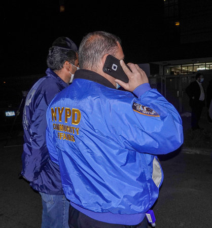 BROOKLYN, NEW YORK - OCTOBER 8, 2020: NYPD Community Affairs officer protects members of the...