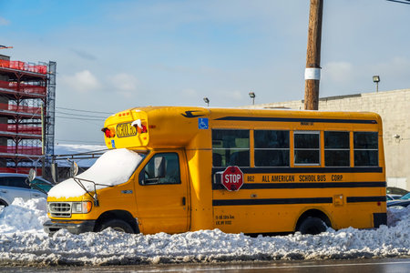 BROOKLYN, NEW YORK - DECEMBER 17, 2020: School bus under snow in Brooklyn, New York after massive...