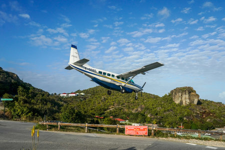 ST. BARTS, FRENCH WEST INDIES - FEBRUARY 3, 2021: St. Barth  Commuter plane landing at Remy de...