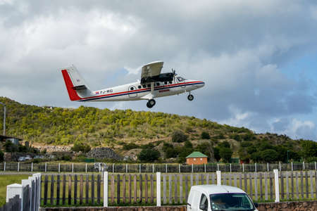 ST. BARTS, FRENCH WEST INDIES - FEBRUARY 3, 2021: Winair plane takes of at Remy de Haenen Airport also known as Saint Barthelemy Airport. At 2,133 ft its runway is one of the shortest in the worldのeditorial素材