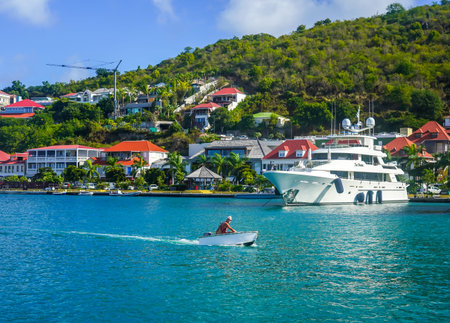 ST BARTS, FRENCH WEST INDIES - FEBRUARY 5, 2021: Mega yachts anchored in Gustavia harbor. It is the...