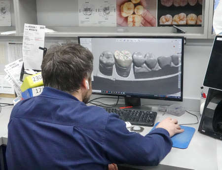 BROOKLYN, NEW YORK - FEBRUARY 11, 2021: Dental technician design new crown for patient using 3D scanner and CAD/CAM softwareのeditorial素材