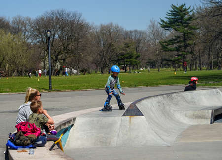 FLUSHING, NEW YORK - APRIL 8, 2021: Unidentified young roller skater in Flushing Meadows Parkのeditorial素材