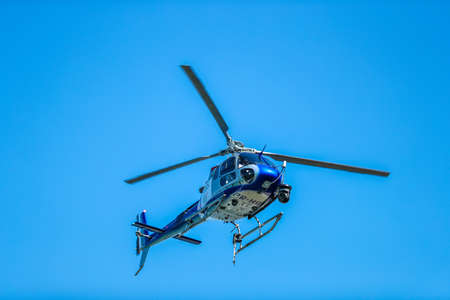 RIO DE JANEIRO, BRAZIL - AUGUST 6, 2016: Olympic Broadcasting Services helicopter, covering the men's Olympic Cycling Road competition at the 2016 Olympic Games in Rio de Janeiroのeditorial素材
