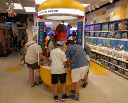 NEW YORK CITY - JULY 22, 2021: Visitors at the LEGO Minifigure Factory at newly opened LEGO flagship store on Fifth Avenue in Manhattan. It allows to design and create a unique LEGO Minifigureのeditorial素材