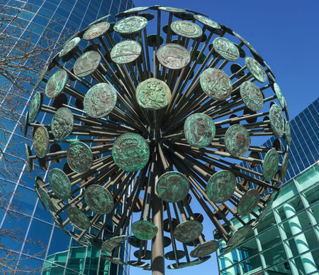 UNIONDALE, NEW YORK - NOVEMBER 8, 2021: Numismatic Sphere by Dorothy Cooper and Harold Caster in Uniondale. At 20 feet tall and weighing 7 tons bronze sphere represents 182 coins from around the worldのeditorial素材