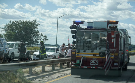 BROOKLYN, NEW YORK - SEPTEMBER 26, 2021: FDNY Engine Company 253 at car crush scene at Belt Parkway...
