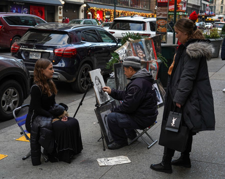 NEW YORK - NOVEMBER 28, 2021:Unidentified street artist drawing portrait of tourist in Midtown Manhattanのeditorial素材