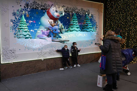 NEW YORK - NOVEMBER 28, 2021: Christmas windows decoration with Tiptoe reindeer at the Macy's Herald Square during Holiday season in midtown Manhattanのeditorial素材