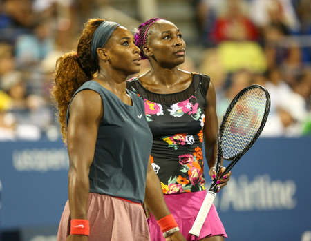 NEW YORK - AUGUST 29, 2013: Grand Slam champions Serena Williams and Venus Williams during their 2013 US Open first round doubles match at Billie Jean King National Tennis Center in New Yorkのeditorial素材