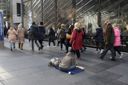NEW YORK - DECEMBER 5, 2021: Homeless woman at 5th Avenue in Midtown Manhattan