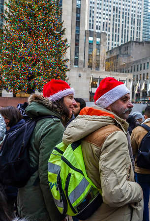 NEW YORK - DECEMBER 5, 2021: Tourists and locals take pictures with Rockefeller Center Christmas Tree in Midtown Manhattanのeditorial素材