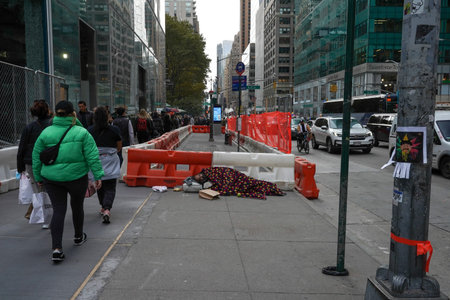 NEW YORK - NOVEMBER 11, 2021: Homeless man at 5th Avenue in Midtown Manhattan