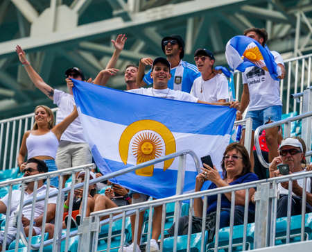 MIAMI GARDENS, FLORIDA - MARCH 30, 2022: Argentinian tennis fans support Francisco Cerundolo of Argentina during his quarter-final match at 2022 Miami Open at the Hard Rock Stadium in Miami Gardensのeditorial素材