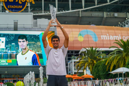 MIAMI GARDENS, FLORIDA - APRIL 3, 2022: Miami Open 2022 Champion Carlos Alcaraz of Spain posing with trophy after his victory over Casper Ruud at the Hard Rock Stadium in Miami Gardens, Floridaのeditorial素材