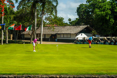 LA ROMANA, DOMINICAN REPUBLIC - JUNE 10, 2021: Golfers practicing at the famous Teeth of the Dog Golf Course of Casa de Campo design by Pete Dyeのeditorial素材