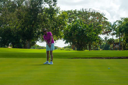 LA ROMANA, DOMINICAN REPUBLIC - JUNE 10, 2021: Female golfer practicing at the famous Teeth of the Dog Golf Course of Casa de Campo design by Pete Dyeのeditorial素材