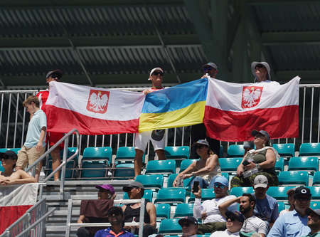 MIAMI GARDENS, FLORIDA - APRIL 2, 2022: Polish tennis fans holding Polish and Ukrainian flags after Miami Open 2022 women's final match won by Iga Swiatek of Poland at the Hard Rock Stadium in Miamiのeditorial素材