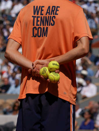 PARIS, FRANCE - JUNE 5, 2022: Ball boy holds Wilson Roland Garros tennis ball at Le Stade Roland Garros in Paris, France. Wilson is an Official Partner of the tournamentのeditorial素材