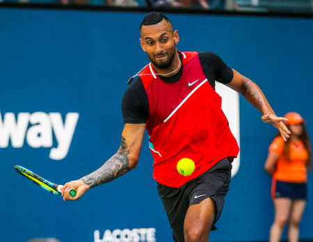 MIAMI GARDENS, FLORIDA - MARCH 27, 2022: Professional tennis player Nick Kyrgios of Australia in action during his 2022 Miami Open round of 32 match at the Hard Rock Stadiumのeditorial素材