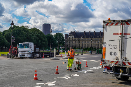 PARIS, FRANCE - JUNE 6, 2022: Road repair site with construction equipment and workers in Paris, Franceのeditorial素材