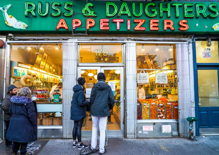 NEW YORK - DECEMBER 5, 2021: Tourists and locals stay in line outside of the famous Russ & Daughters appetizing store, opened in 1914 in Lower East Side in Manhattanのeditorial素材
