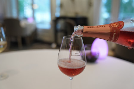 EPERNAY, FRANCE - SEPTEMBER 24, 2022: Bartender pouring Taittinger rose champagne into glassのeditorial素材