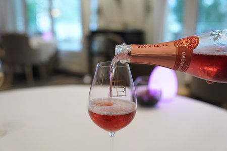 EPERNAY, FRANCE - SEPTEMBER 24, 2022: Bartender pouring Taittinger rose champagne into glassのeditorial素材