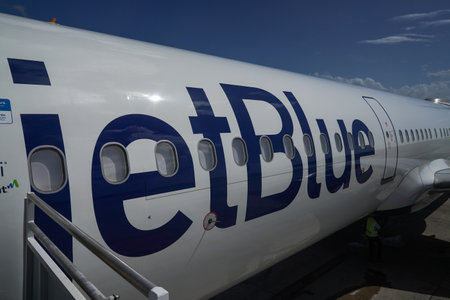 ST. GEORGE, GRENADA - JANUARY 3, 2023: JetBlue plane on tarmac at Maurice Bishop International Airport in Grenadaのeditorial素材